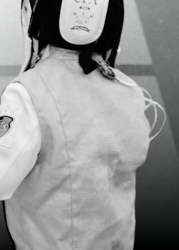 A young Triumph Fencing Studio fencer in whites and mask at the studio in Taman Tun Dr Ismail.